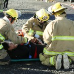 Firefighters "package" a simulated patient.