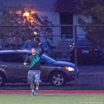 A member of Scared Hitless catches a flyball at the warning track.